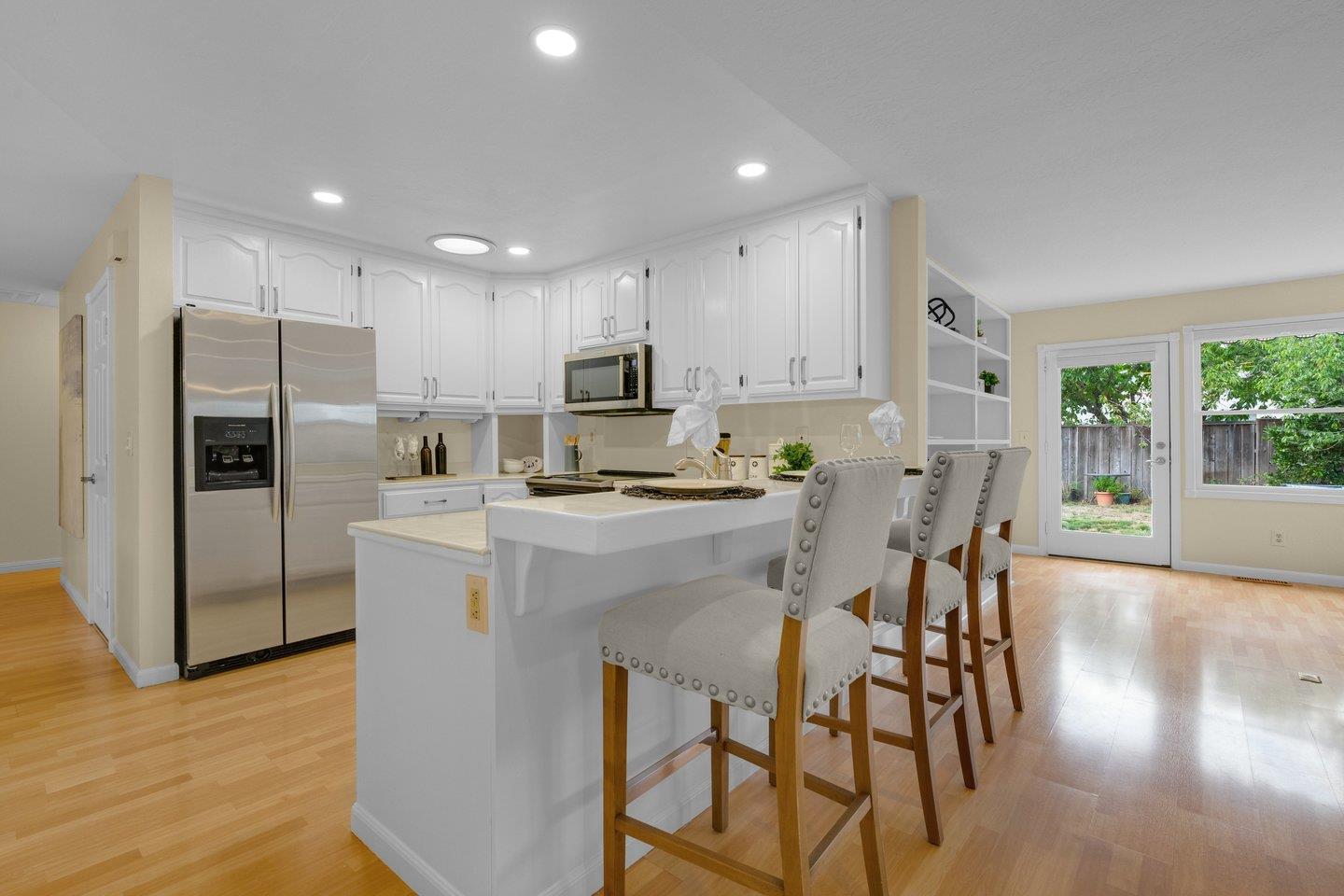 2153 Lacey Drive Milpitas, CA 95035 - Photo 15 of 42 a kitchen with kitchen island a refrigerator stove microwave and cabinets
