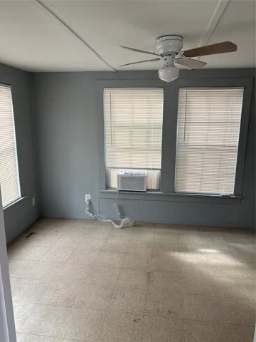 an empty room with a empty space and windows