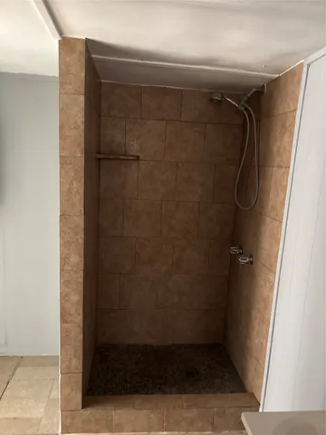 a bathroom with a glass door shower