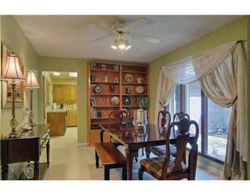 a view of a dining room with furniture and a chandelier