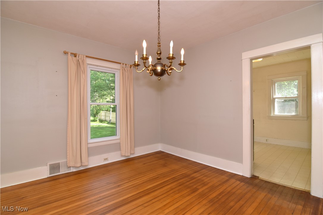 272 Miles Road Chagrin Falls, OH 44022 - Photo 15 of 22 Empty room with a chandelier and hardwood / wood-style floors