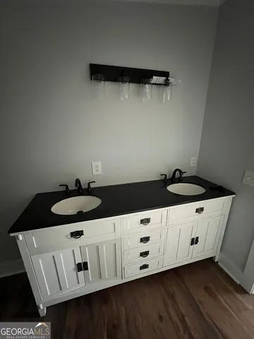 a kitchen with granite countertop white cabinets and a stove