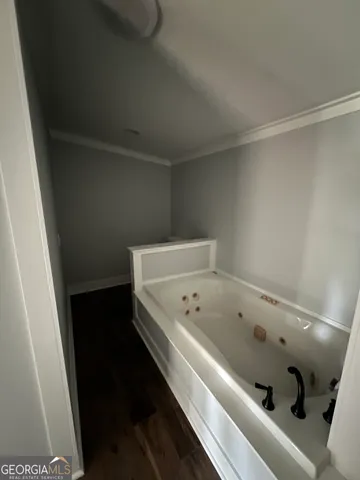 a bathroom with a bathtub and shower