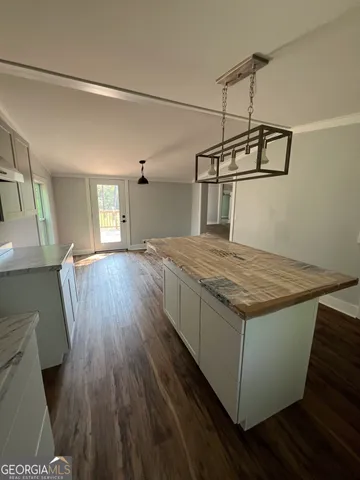 a view of a kitchen with a sink and wooden floor