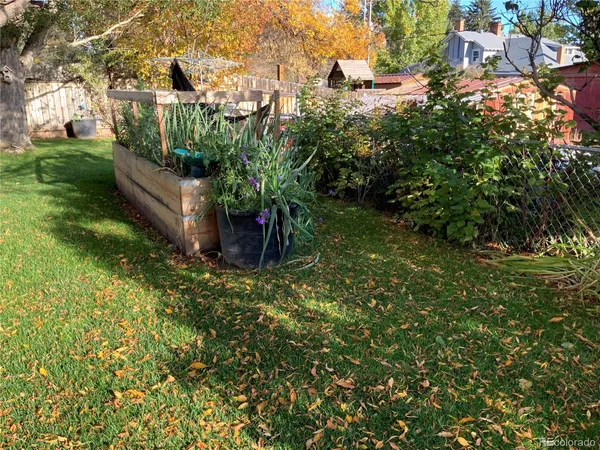 a view of a garden with a house