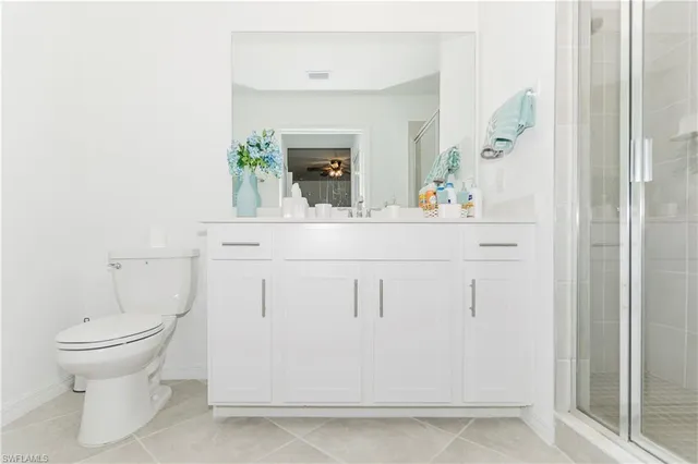 a bathroom with a sink a toilet and mirror