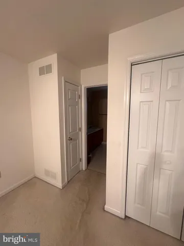 a view of an empty room with closet
