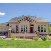 a front view of a house with a yard table and chairs