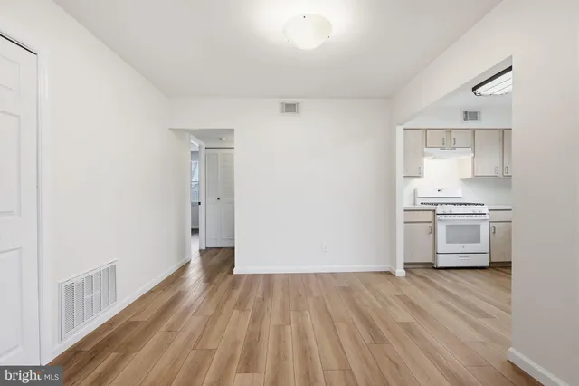 a view of kitchen with sink and refrigerator