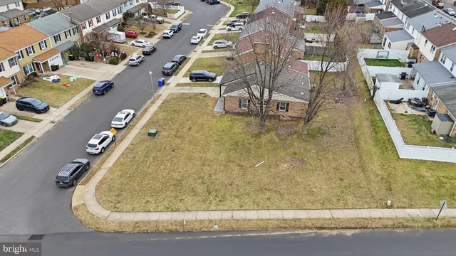 an aerial view of residential house with parking