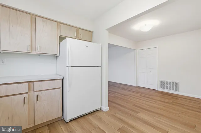a white refrigerator freezer sitting in a kitchen