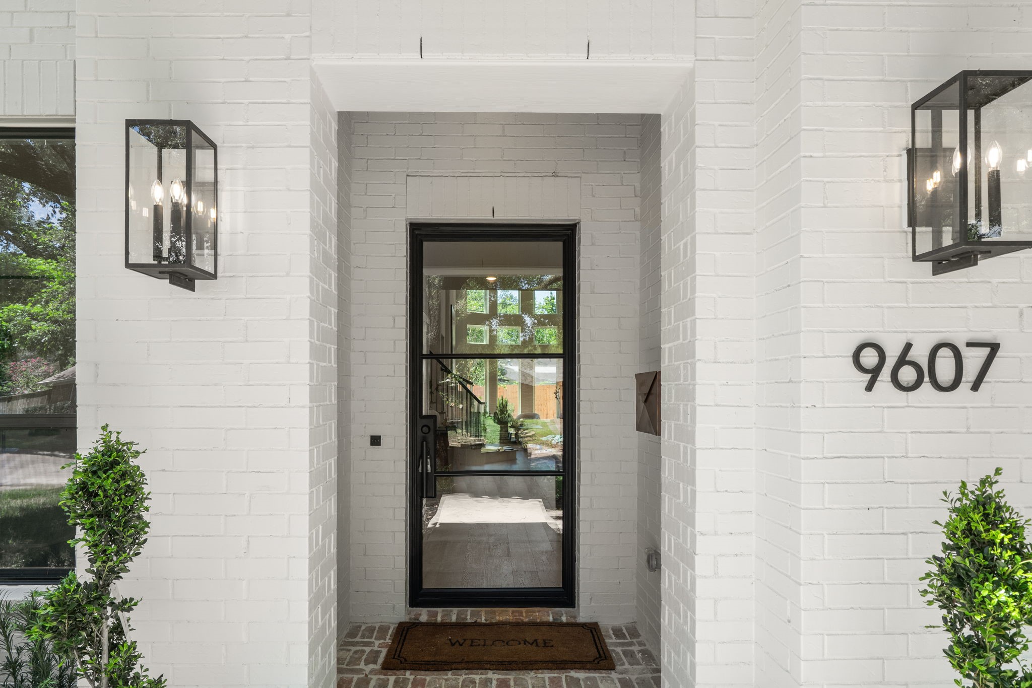 9839 Warwana Road Houston, TX 77080 - Photo 28 of 40 a hallway with a large window and potted plants