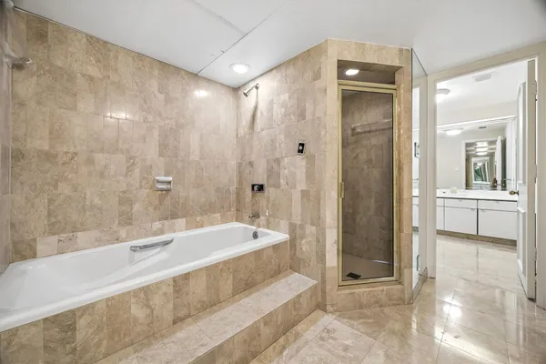 a bathroom with a bathtub and a shower