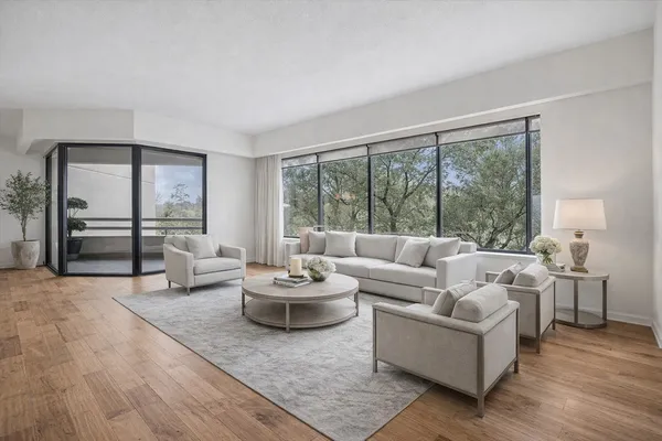 a living room with furniture and a large window