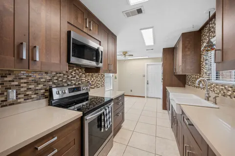 a kitchen with a sink and a stove top oven