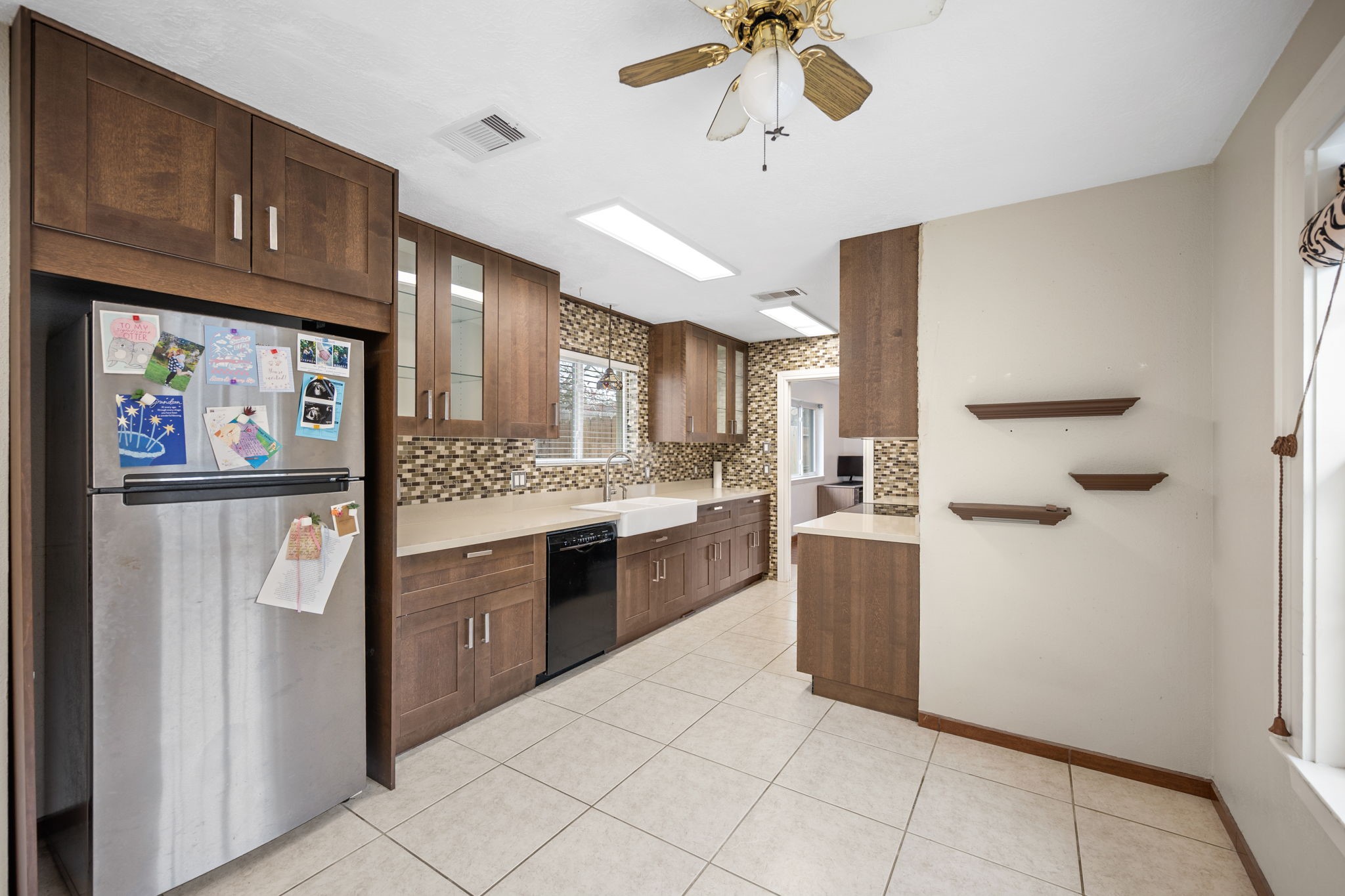 2327 Colonial Ridge Drive Friendswood, TX 77546 - Photo 15 of 27 a kitchen with stainless steel appliances kitchen island granite countertop a refrigerator and a sink