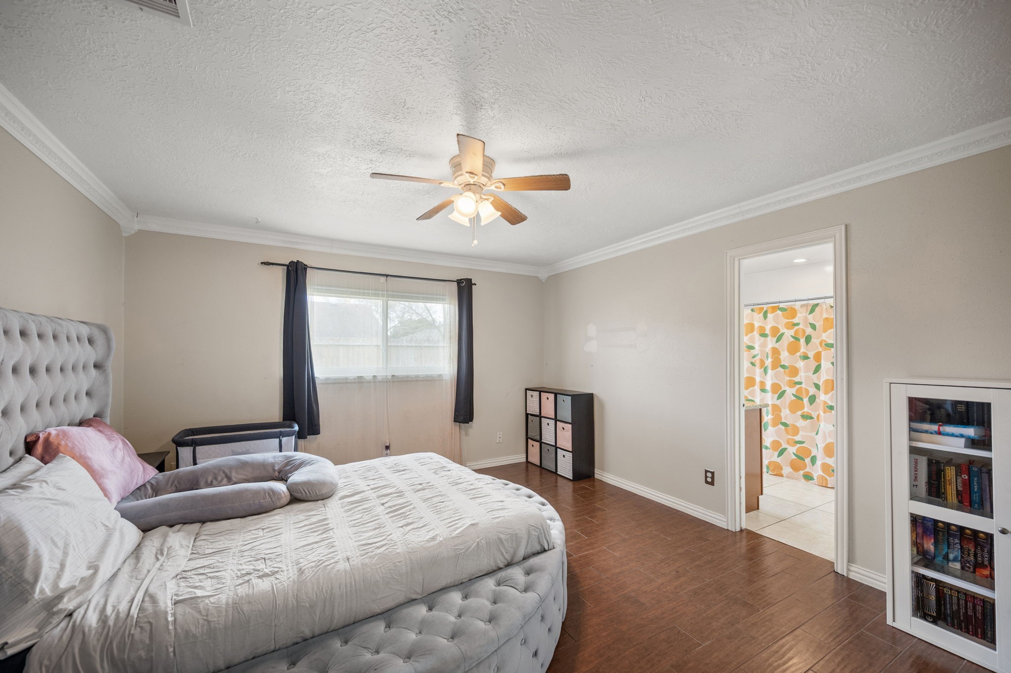 2327 Colonial Ridge Drive Friendswood, TX 77546 - Photo 16 of 27 a bedroom with a large bed cabinets and a window