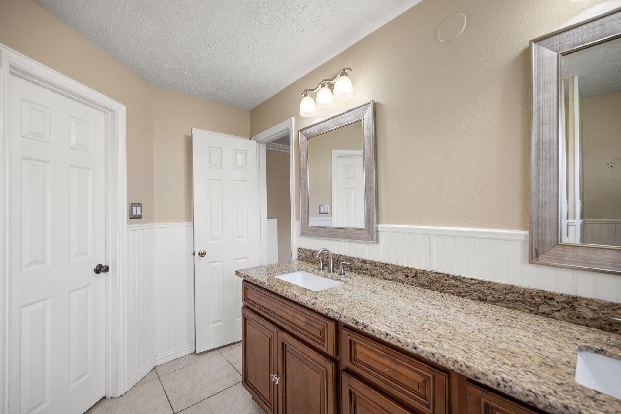 2327 Colonial Ridge Drive Friendswood, TX 77546 - Photo 19 of 27 a bathroom with a granite countertop sink and a mirror