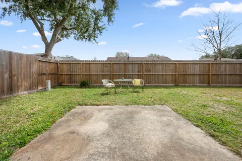 a view of a house with backyard and sitting area