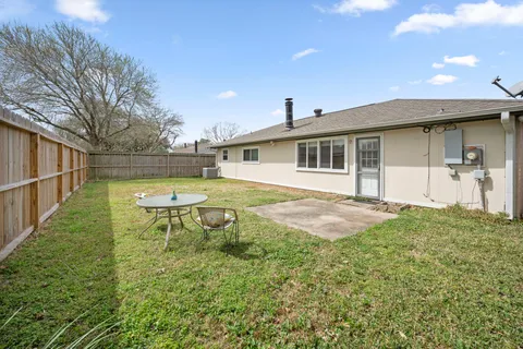 a backyard of a house with plants and trees