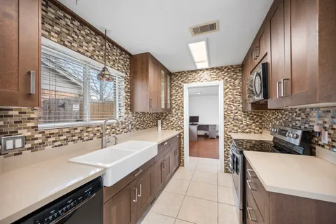 a large kitchen with a sink and cabinets