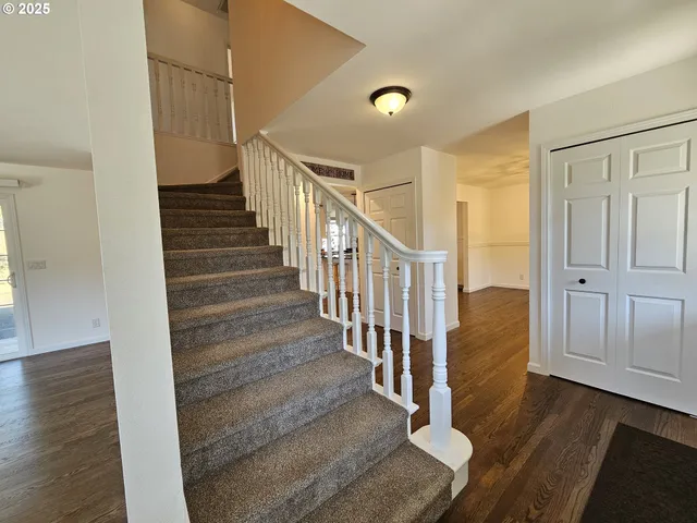 a view of entryway and hall with wooden floor