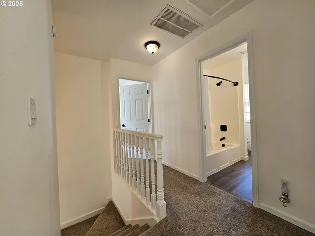 a view of a hallway and door