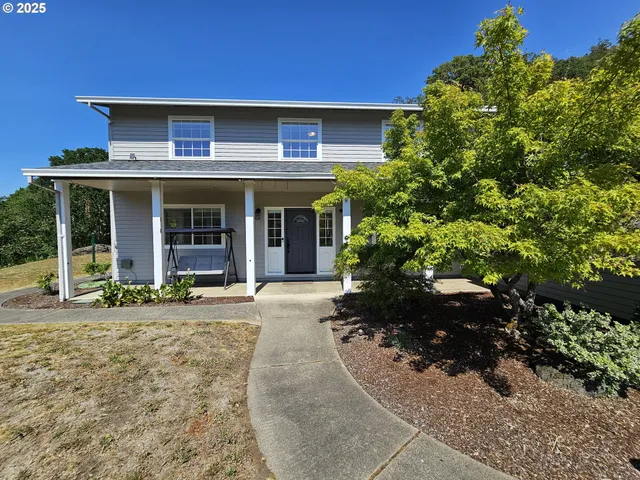a front view of a house with a garden