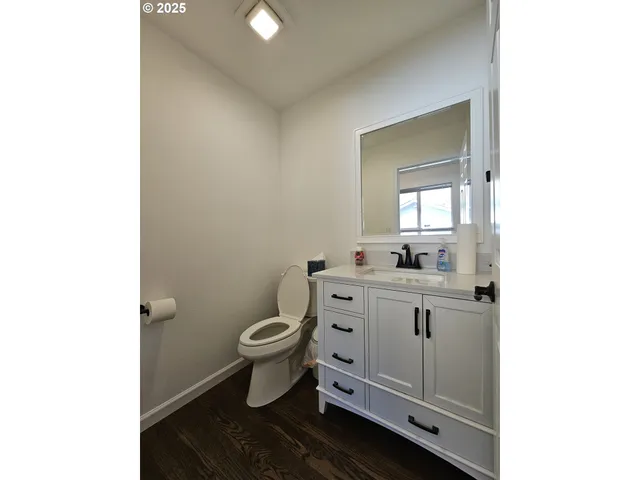 a bathroom with a toilet sink and mirror