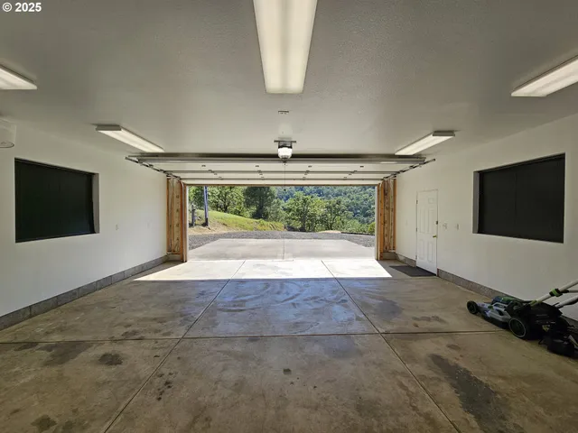 a view of an empty room with a fireplace and a window
