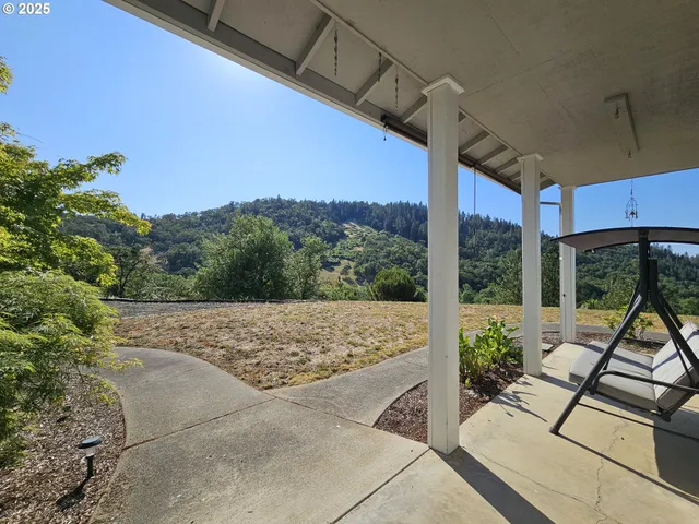 a view of yard with patio
