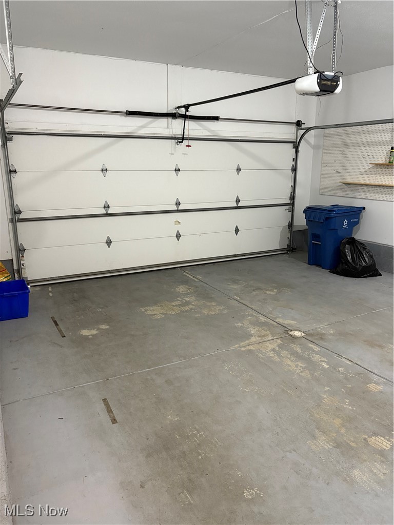 6695 Clingan Road, Unit 24 Youngstown, OH 44514 - Photo 23 of 26 Garage featuring a garage door opener
