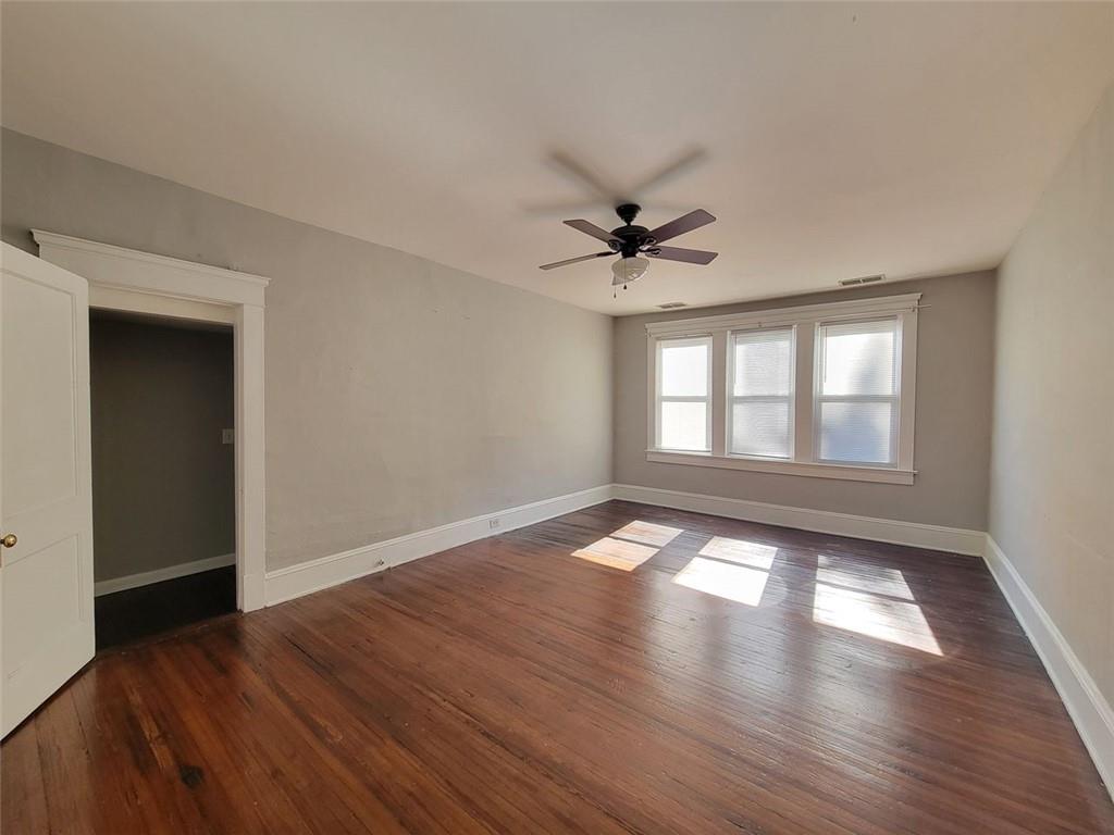 976 Delaware Avenue Southeast, Unit 2 Atlanta, GA 30316 - Photo 11 of 28 a view of an empty room with wooden floor and a window