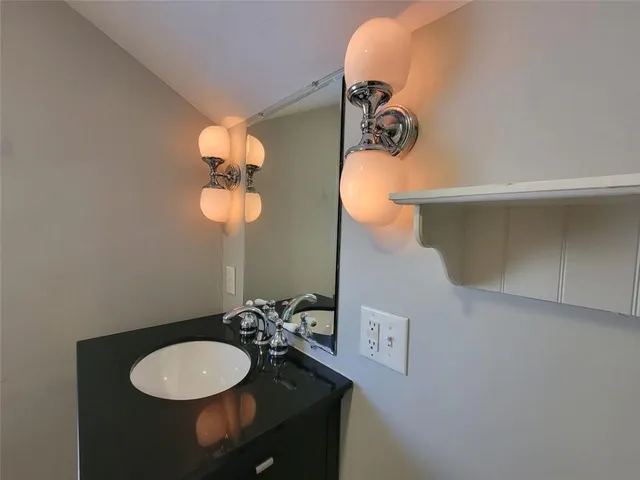 a bathroom with a sink and mirror