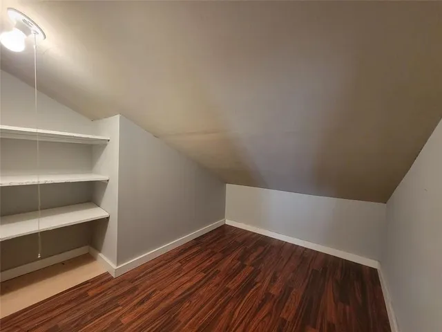 a view of a room with wooden floor