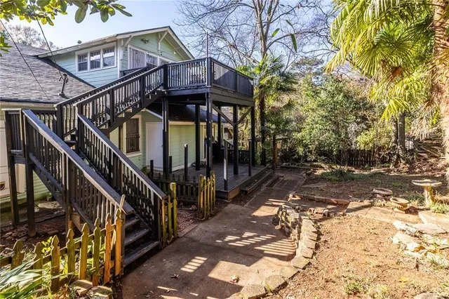 a view of a house with wooden fence