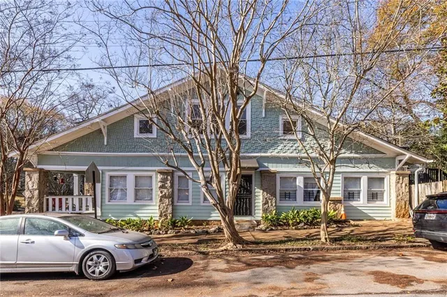 a car parked in front of a white house