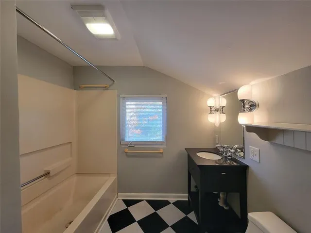 a bathroom with a bathtub and a sink