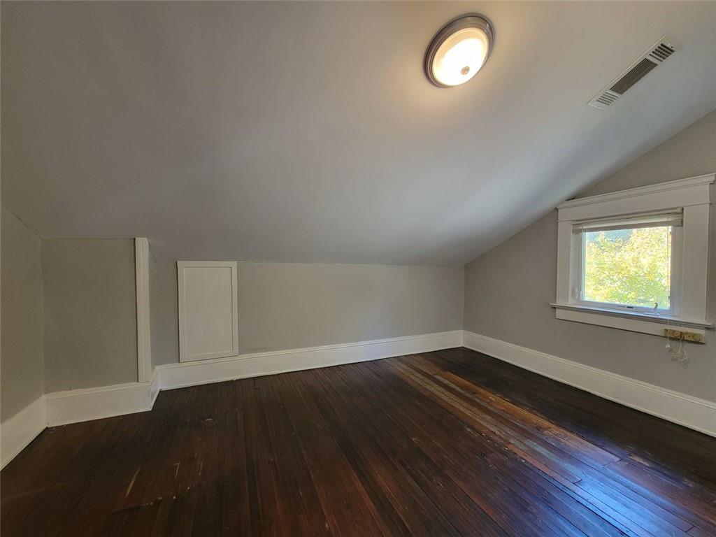 976 Delaware Avenue Southeast, Unit 2 Atlanta, GA 30316 - Photo 10 of 28 an empty room with wooden floor and windows