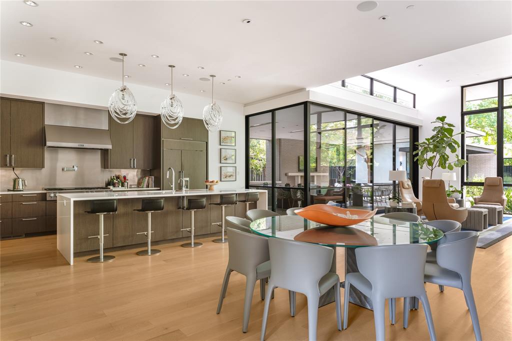 5420 Surrey Circle Dallas, TX 75209 - Photo 14 of 40 a dining room with furniture a chandelier and wooden floor