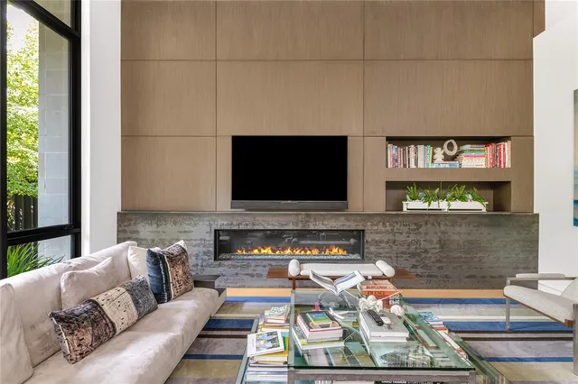 a living room with furniture fireplace and flat screen tv