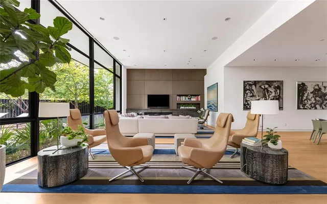 a living room with fireplace furniture and a large window