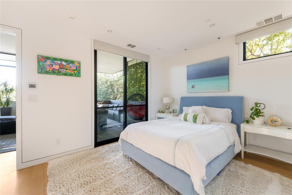 5420 Surrey Circle Dallas, TX 75209 - Photo 25 of 40 a bedroom with a bed a wall painting and a window