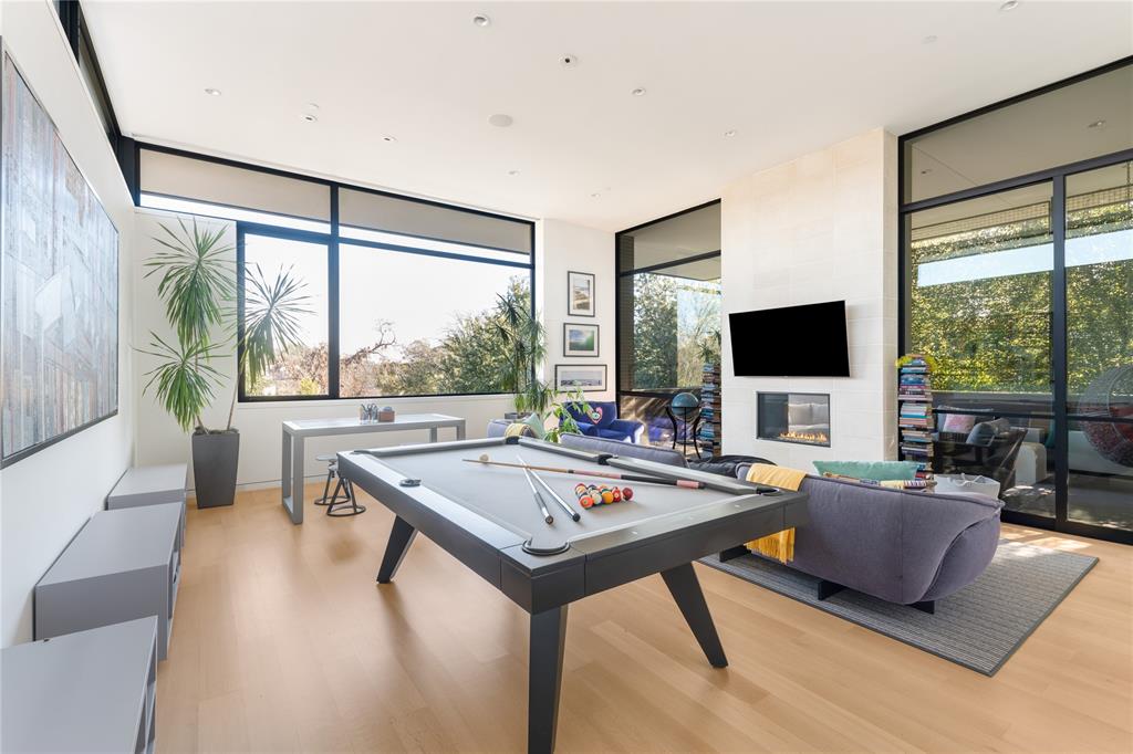 5420 Surrey Circle Dallas, TX 75209 - Photo 30 of 40 a living room with furniture a flat screen tv and a large window