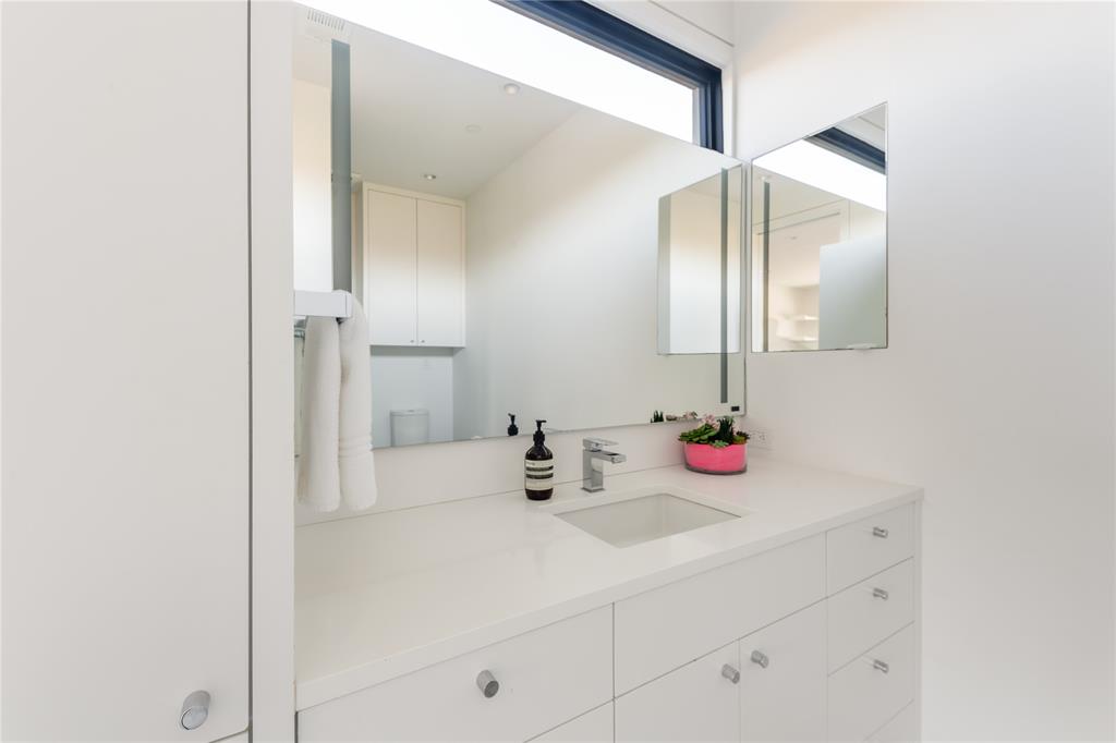 5420 Surrey Circle Dallas, TX 75209 - Photo 33 of 40 a bathroom with a sink and a mirror