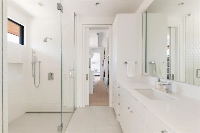 a kitchen with a table chairs and flat screen tv