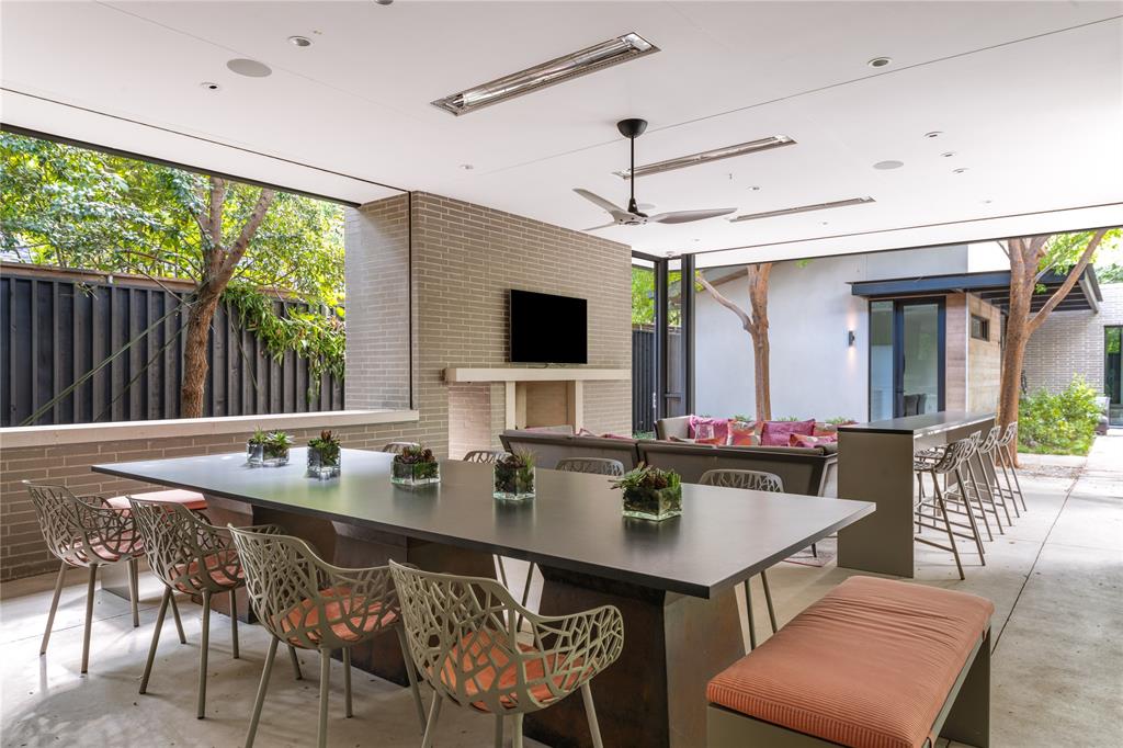 5420 Surrey Circle Dallas, TX 75209 - Photo 36 of 40 a kitchen with a table chairs and flat screen tv