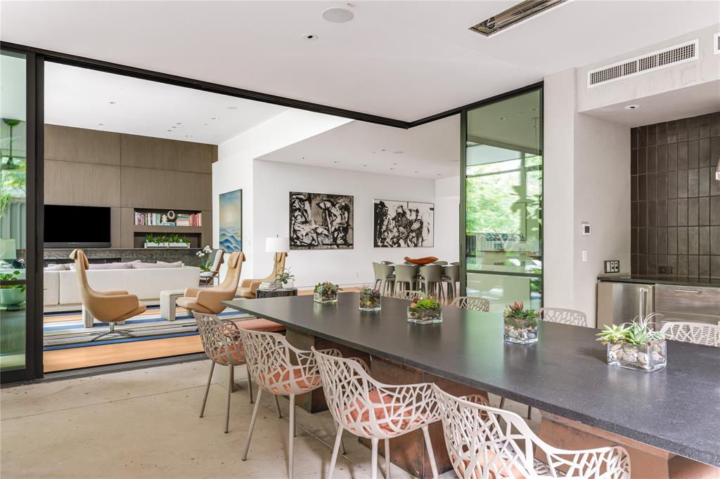 5420 Surrey Circle Dallas, TX 75209 - Photo 38 of 40 a dining room with furniture and a flat screen tv