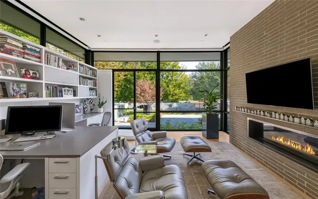 a living room with furniture a rug and a large window