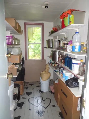 a room with furniture a rug toys and a window